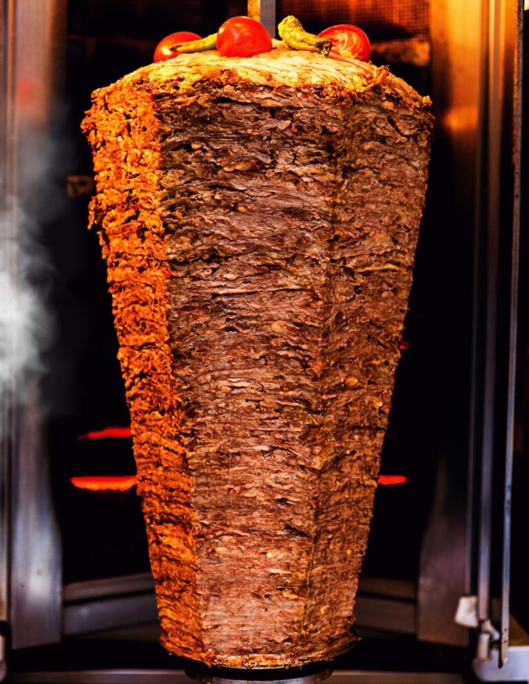 Vertical rotisserie with slow-roasted beef shawarma – authentic halal Mediterranean cooking at Shawarma & Mediterranean Flavors Edmonton.